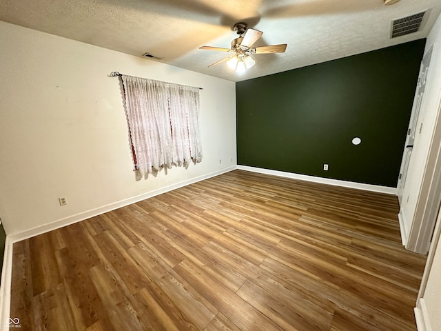 unfurnished bedroom with wood-type flooring, a textured ceiling, and ceiling fan