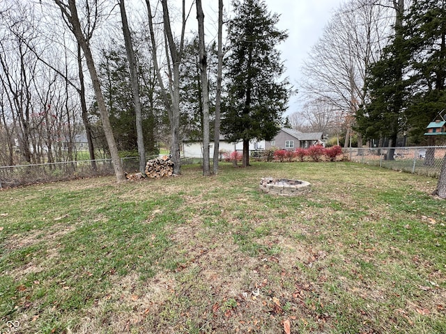 view of yard with a fire pit