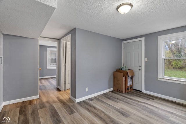 foyer with hardwood / wood-style floors and a textured ceiling