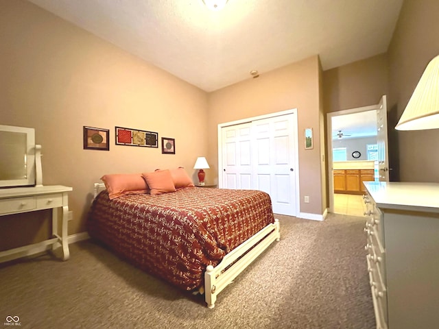 bedroom featuring dark colored carpet, ensuite bathroom, and a closet