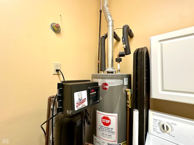 utility room featuring gas water heater and washer / dryer