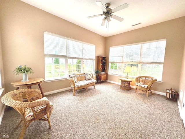 sitting room with ceiling fan and carpet floors