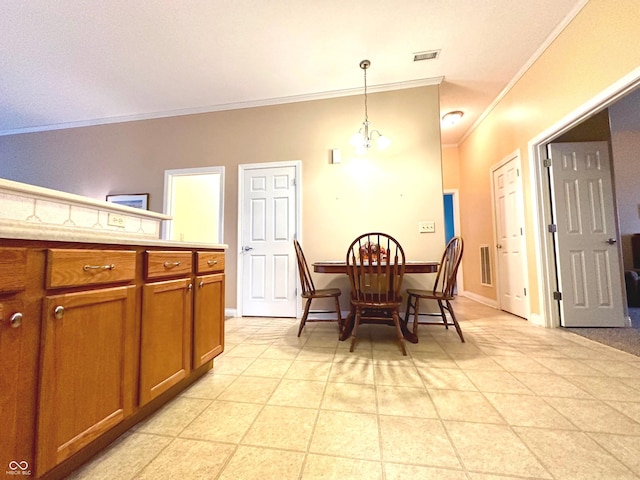 tiled dining space featuring a chandelier and ornamental molding