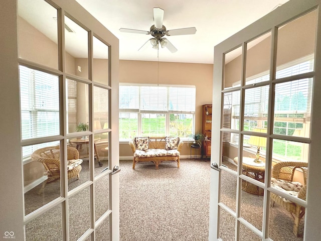 sunroom / solarium with a wealth of natural light, french doors, and ceiling fan