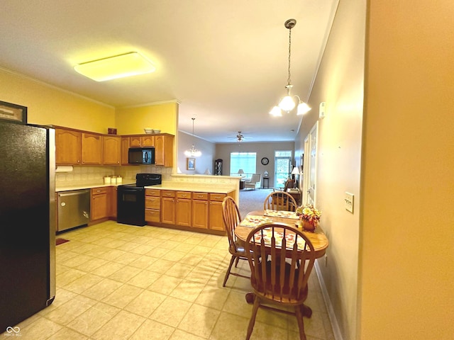 kitchen with backsplash, kitchen peninsula, decorative light fixtures, black appliances, and ceiling fan with notable chandelier