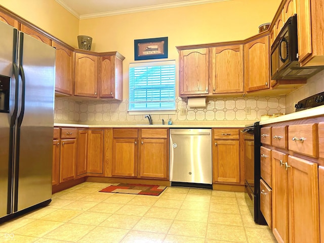 kitchen with sink, tasteful backsplash, ornamental molding, and black appliances