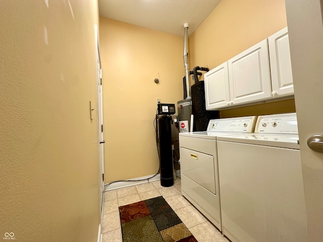 washroom featuring light tile patterned floors, cabinets, and independent washer and dryer