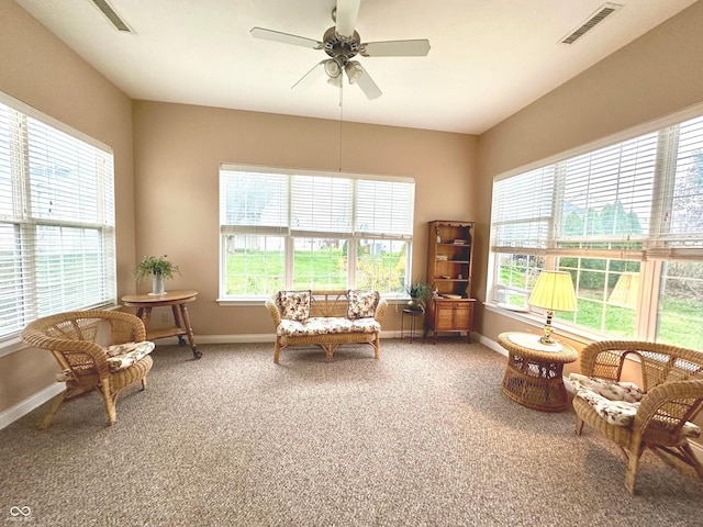 living area featuring ceiling fan and carpet floors