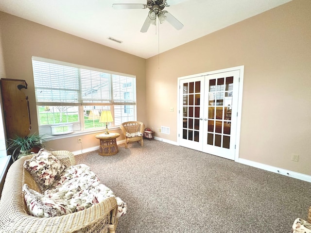 living area featuring ceiling fan, french doors, and carpet floors