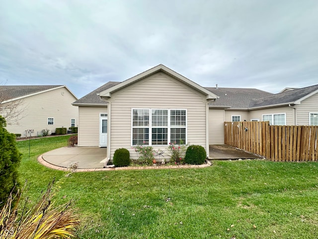 rear view of property with a lawn and a patio area