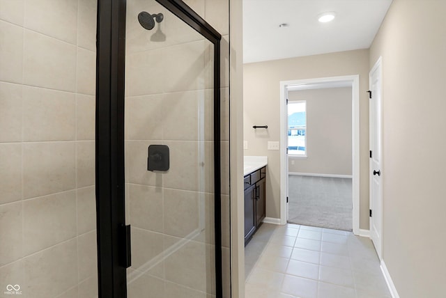 bathroom featuring tile patterned floors, vanity, and a shower with door