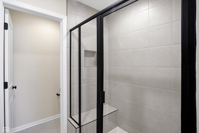 bathroom featuring a shower with shower door