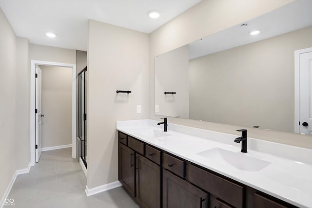 bathroom with vanity, an enclosed shower, and tile patterned floors