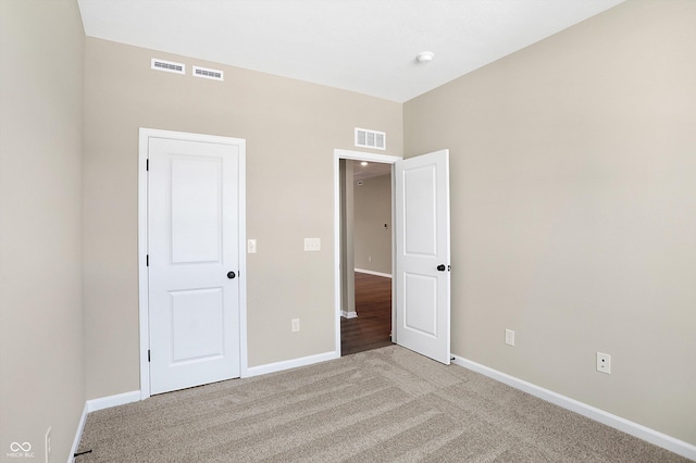 unfurnished bedroom with light carpet