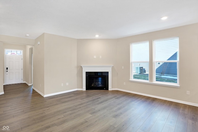 unfurnished living room featuring hardwood / wood-style flooring