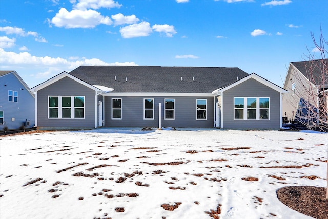 view of snow covered rear of property