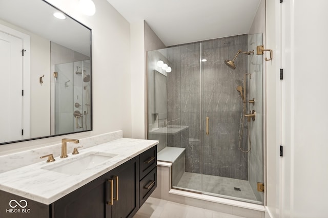 bathroom featuring tile patterned flooring, vanity, and walk in shower