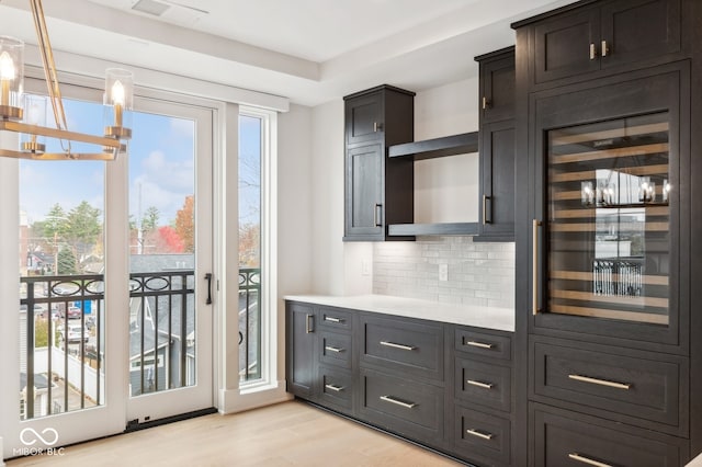 doorway with bar area and light hardwood / wood-style flooring