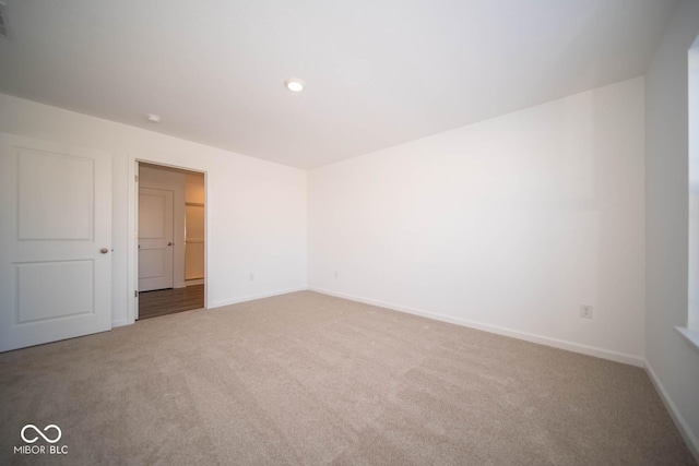 spare room featuring carpet floors, visible vents, baseboards, and recessed lighting