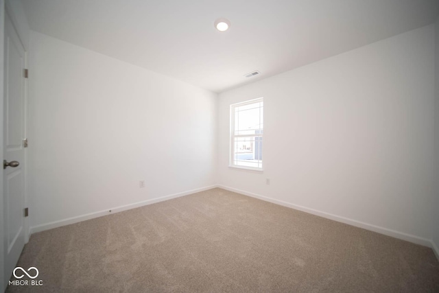 carpeted spare room with recessed lighting, visible vents, and baseboards