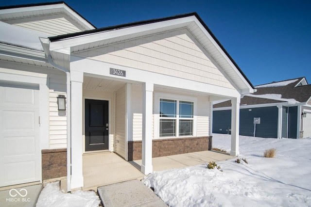 exterior space featuring a porch and a garage