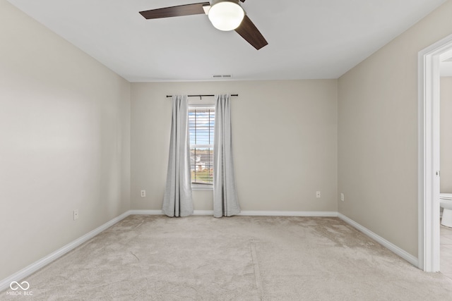 spare room with light carpet and ceiling fan