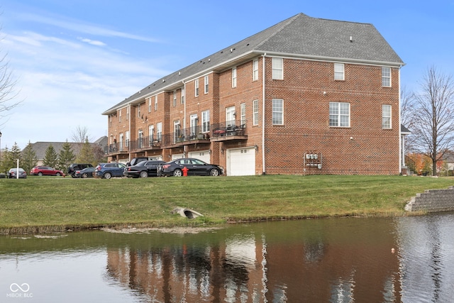 view of building exterior with a garage and a water view