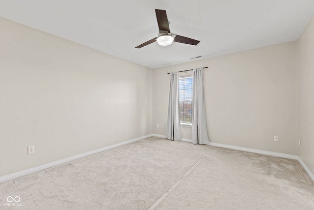 carpeted spare room featuring ceiling fan