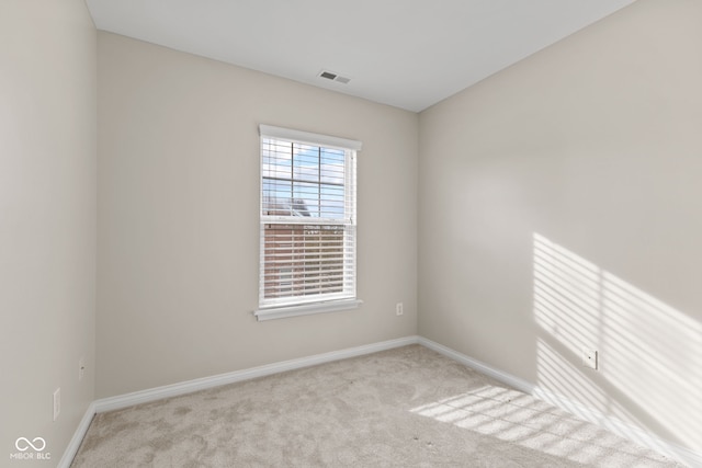 empty room featuring light carpet