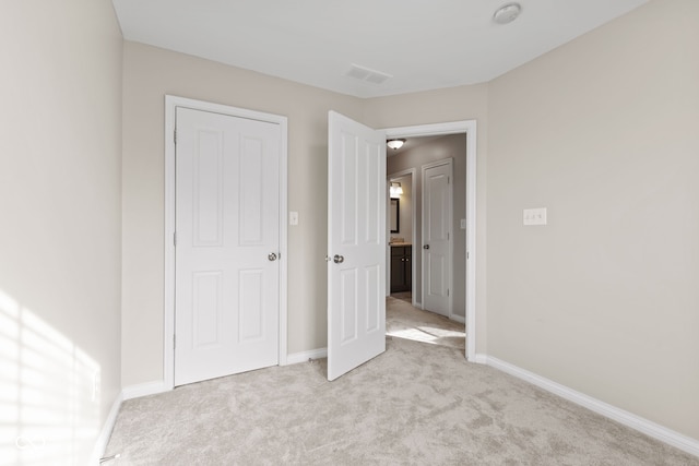 unfurnished bedroom with light carpet