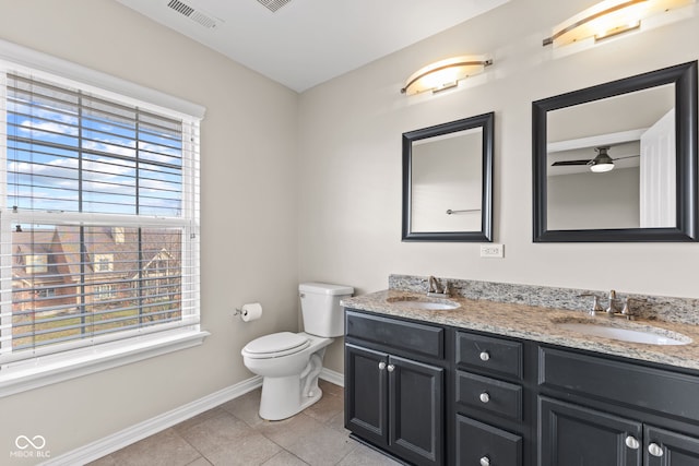 bathroom with tile patterned floors, ceiling fan, vanity, and a healthy amount of sunlight