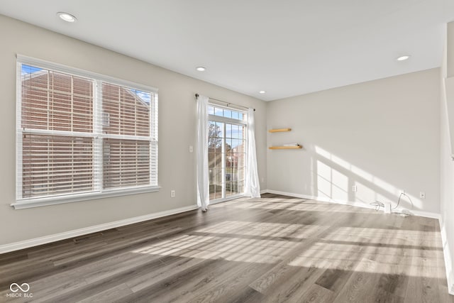 unfurnished room with wood-type flooring