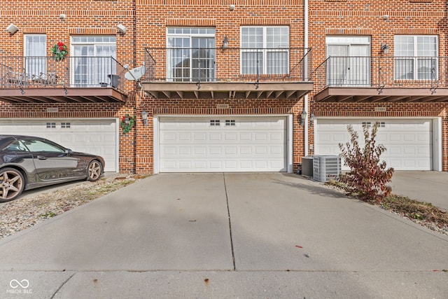 view of front of home featuring a garage and central air condition unit