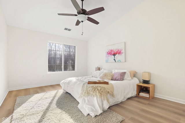 bedroom featuring wood-type flooring, high vaulted ceiling, and ceiling fan