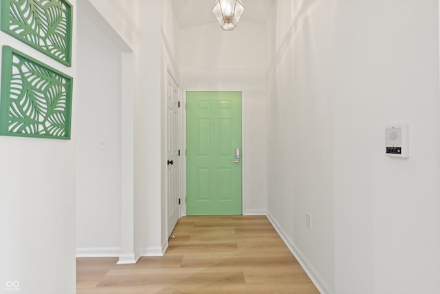 hallway with light hardwood / wood-style floors