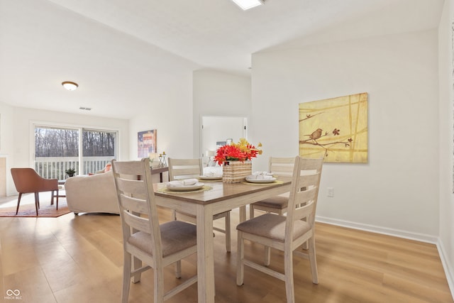 dining space with light hardwood / wood-style floors