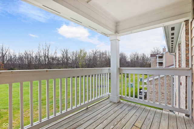 wooden terrace featuring a yard