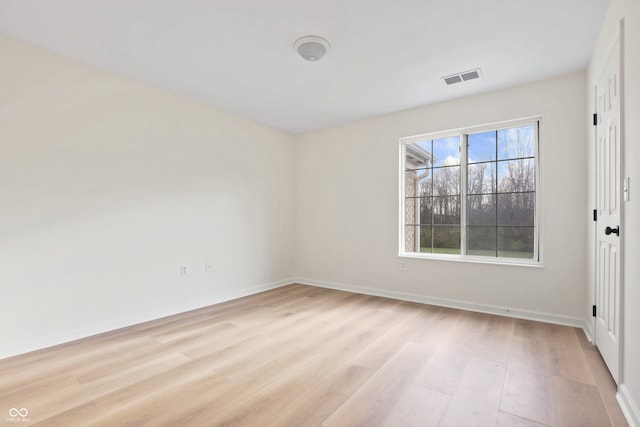 unfurnished room with light wood-type flooring