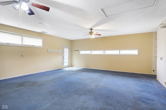 unfurnished room featuring ceiling fan, a healthy amount of sunlight, and dark carpet