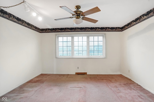 unfurnished room featuring rail lighting, light colored carpet, and ceiling fan