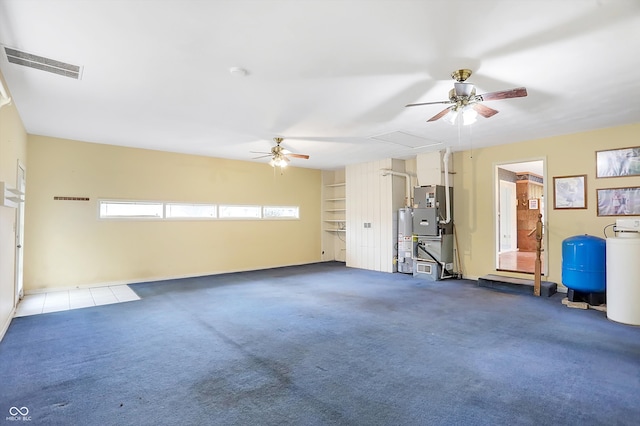 garage featuring ceiling fan and water heater