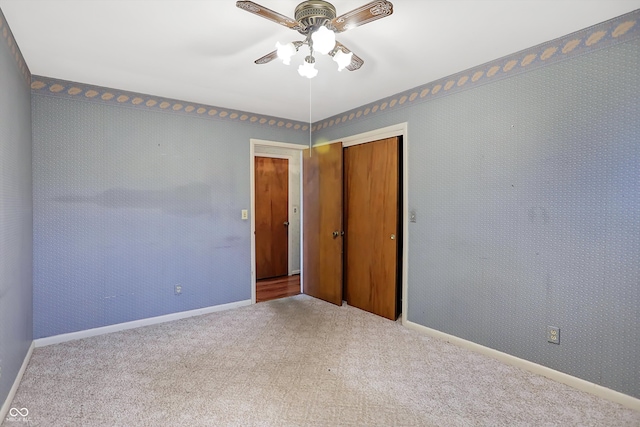 empty room featuring light carpet and ceiling fan