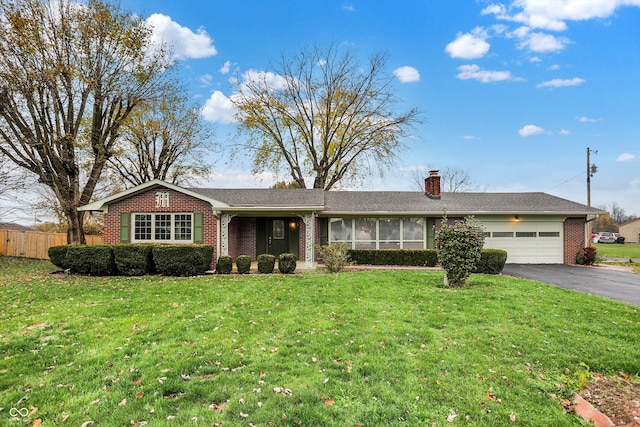 ranch-style house featuring a front lawn and a garage