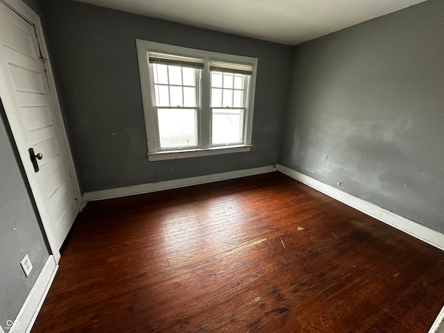 empty room with dark wood-type flooring