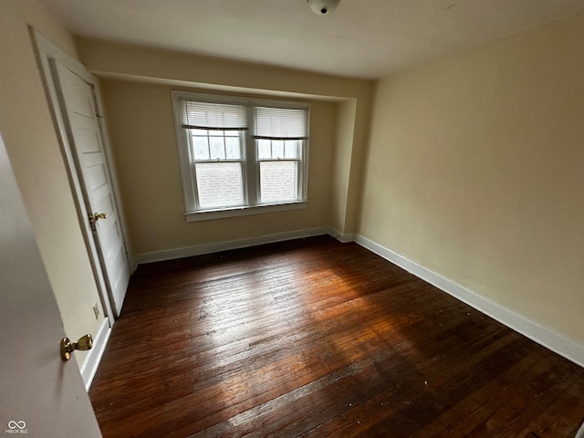 empty room featuring dark hardwood / wood-style flooring