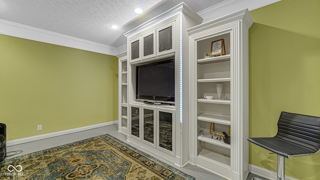 carpeted living room with built in shelves, crown molding, and a textured ceiling