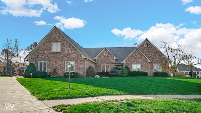 view of front of property with brick siding and a front lawn