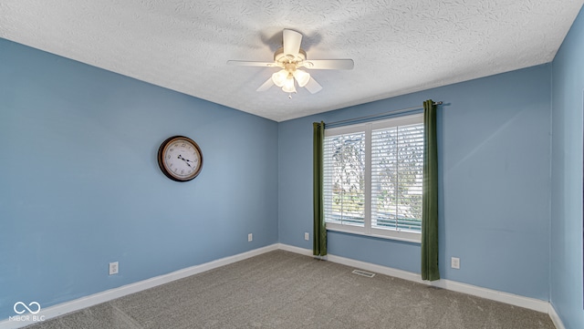 carpeted empty room featuring a textured ceiling and ceiling fan