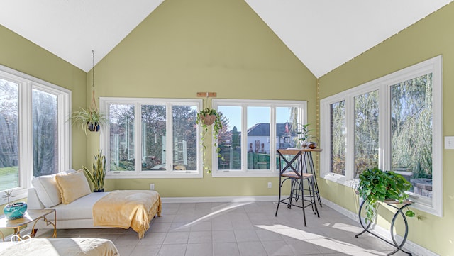 sunroom / solarium with lofted ceiling and a healthy amount of sunlight