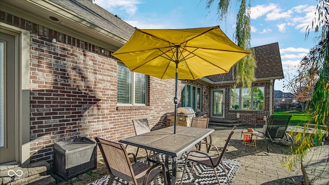 view of patio featuring a grill and outdoor dining area